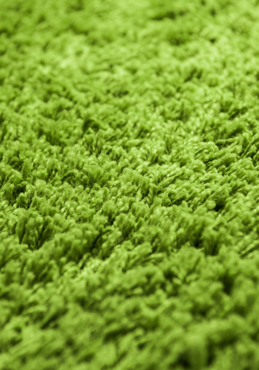 Close up of green yarn carpet for background.